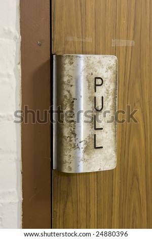 Dirty disgusting germ and bacteria covered public door pull handle.