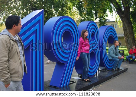 MOSCOW, RUSSIA - SEPTEMBER 01: People in Gorky park near 1980 sign in conjunction with Moscow 865th birthday on September 01, 2012 in Moscow, Russia.