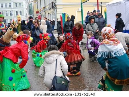 MOSCOW, RUSSIA - MARCH 16: People dancing folk dances on the street. Shrovetide celebration in Moscow city center. Taken on March 16, 2013 in Moscow, Russia.