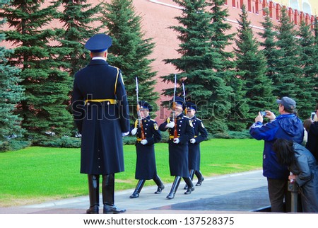 MOSCOW - MAY 01: Tourists taking photos of marching soldiers. Guard of Honor change at the Tomb of unknown soldier in Moscow. Taken on May 01, 2013 in Moscow, Russia.