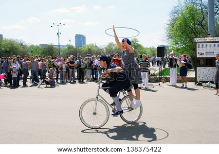 MOSCOW, RUSSIA - MAY 09: Young actors drives the bicycle. Performance in the Gorky park. Victory Day celebration on May 09, 2013 in Moscow.