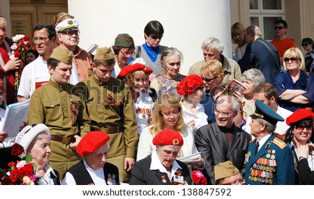MOSCOW, RUSSIA - MAY 09: War veterans sing war songs on the Theater Square, by the Bolshoi Theater, traditional place for veterans\' meeting. Taken on May 09, 2013 in Moscow.