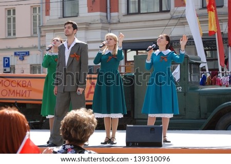 MOSCOW, RUSSIA - MAY 09: Young actors dressed in vintage clothes perform on stage in Moscow city center. Victory Day celebration on May 09, 2013 in Moscow.