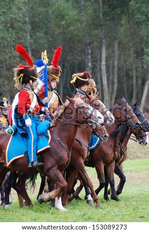 MOSCOW REGION - SEPTEMBER 02: Reenactors dressed as Napoleonic war soldiers ride horses on September 02, 2012 in Borodino, Moscow Region, Russia. They reenact the Borodino battle held in 1812.