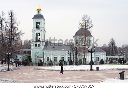 MOSCOW - FEBRUARY 22, 2014: Architecture of Tsaritsyno park in Moscow, Russia, in winter. People walk by an old orthodox church. A popular touristic landmark in Moscow.