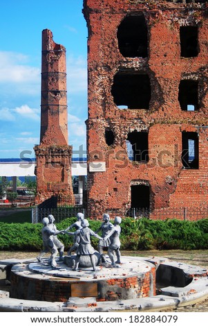 VOLGOGRAD, RUSSIA - SEPTEMBER 16, 2013: A statue of dancing children and a destroyed house. View of Stalingrad battle war memorial in Volgograd, Russia. A popular touristic landmark.