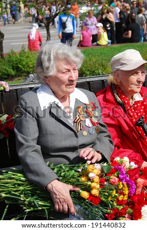 MOSCOW, RUSSIA - MAY 09: Portrait of two war veteran women holding flowers. Victory Day celebration on May 09, 2013 in Moscow.