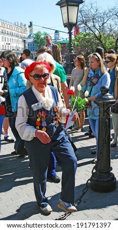 MOSCOW - MAY 09, 2014: Portrait of a war veteran woman wearing a red hat taken on the Theater Square in Moscow, a popular place of veterans meeting. Victory Day celebration in Moscow.
