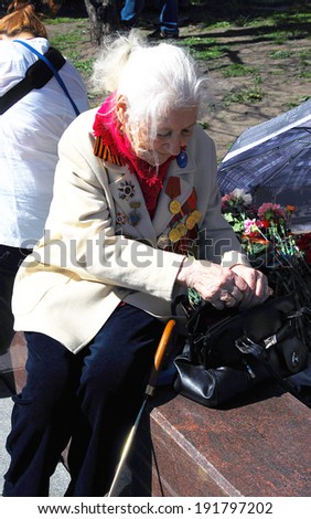 MOSCOW - MAY 09, 2014: Portrait of a senior war woman veteran, she sits on the bench. Victory Day celebration in Moscow.