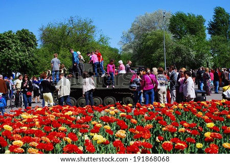 MOSCOW - MAY 09, 2014: Vintage machine gun. People take photos of it. Victory Day celebration in Gorky park in Moscow.
