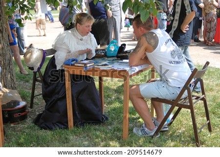 MOSCOW - JUNE 07, 2014: Fortune teller woman in historical costume. Times and Ages International Historical Festival in Kolomenskoye park, Moscow.
