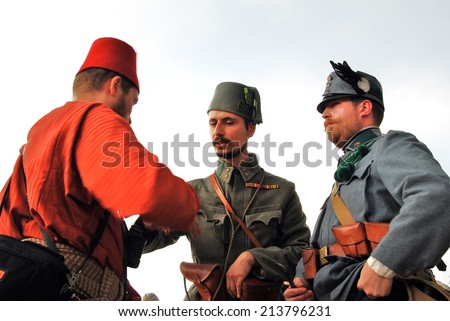 MOSCOW - JUNE 07, 2014: Portrait of three men speaking to each other, they wear historical costumes. Times and Ages International Historical Festival in Kolomenskoye park, Moscow.