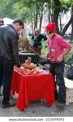 MOSCOW - SEPTEMBER 06, 2014: Portrait of a souvenir seller. Moscow City Day celebration in Moscow city center.