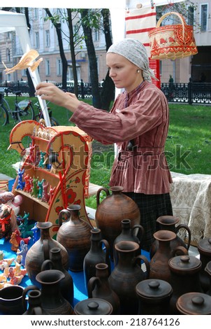 MOSCOW - SEPTEMBER 06, 2014: Portrait of a souvenir seller. Moscow City Day celebration in Moscow city center.