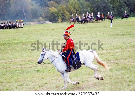 MOSCOW REGION - SEPTEMBER 07, 2014: Reenactor dressed as Napoleonic war soldier rides a horse at Borodino battle historical reenactment.