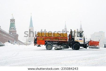 MOSCOW, RUSSIA - MARCH 15, 2013: View of the Red Square in Moscow at extreme snowstorm. Cars clears the square from snow. Red Square is a popular touristic landmark, UNESCO World Heritage Site.