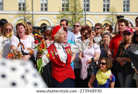 MOSCOW, RUSSIA - MAY 09: War veterans sing war songs on the Theater Square; by the Bolshoi Theater, traditional place for veterans' meeting. Taken on May 09, 2013 in Moscow.
