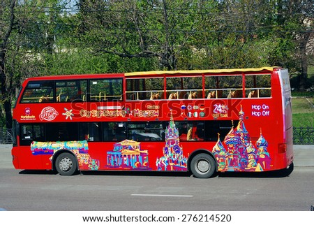 MOSCOW - MAY 06, 2015: Touristic bus red double-decker in Moscow city center. Green trees background. Bus tours is a popular entertainment for tourists in Moscow.