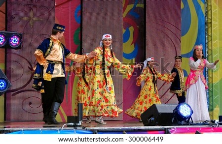 MOSCOW - JULY 18, 2015: Singer and dancers on stage. Sabantui celebration in Moscow, in Kolomenskoye park. Sabantui is a national Tatar and Bashkir festival, celebration of end of spring field work.