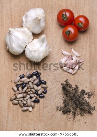 Different ingredients for meals on a wood cutting board.