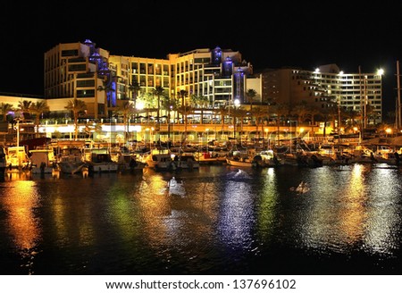 EILAT, ISRAEL - APR. 12: night view on  marina and moored yachts and boats and modern hotels in popular resort  - Eilat of Israel on April 12, 2013 Eilat, Israel