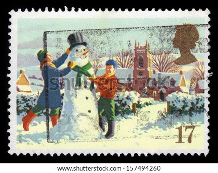 GREAT BRITAIN - CIRCA 1990: A stamp printed in the Great Britain shows Christmas - Building a Snowman , circa 1990