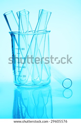 Chemistry laboratory glassware - beaker and test tubes in a pale blue hue with reflection