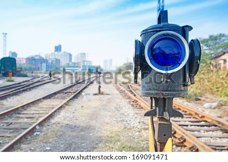 Traffic light shows blue  signal on railway