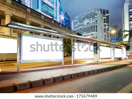 Blank billboard on bus stop at night