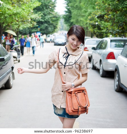 Teenage girl walking in the street with a big smile