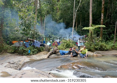 PAHANG, MALAYSIA -FEB 20 : Unidentified man camping at waterfall in deep jungle on February 20, 2015 in Maran, Pahang, Malaysia.