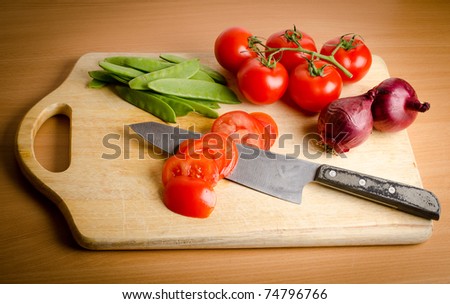 a bunch of fresh vegetables on a wooden cutting board