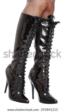 Black shiny patent leather high heeled boots isolated on a white background