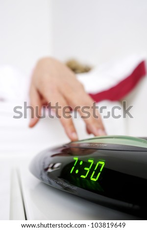 woman\'s hand that turns off the alarm in the morning