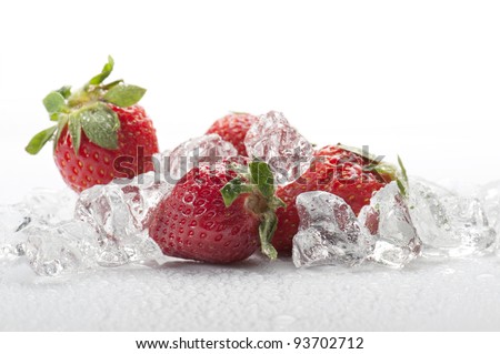 frozen strawberries with ice cubes, on white background