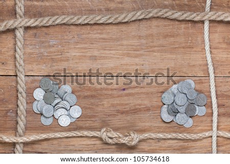 Old wood texture with rope frame and antique coins