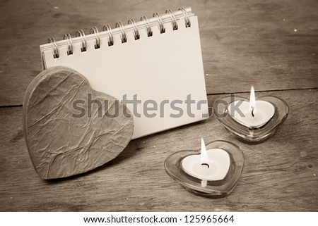 Heart shape valentine candles, note paper on wooden background