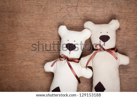 Handmade toy bears pair on wood