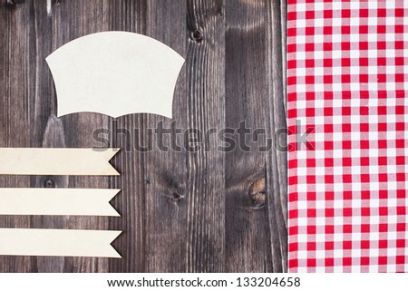 Tablecloth textile, paper labels on wood scrapbook background