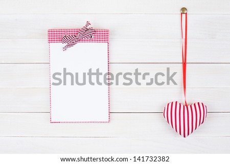 Calendar and heart hang on white wood wall background