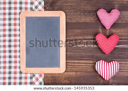 Tablecloth, menu board, hearts on wooden background