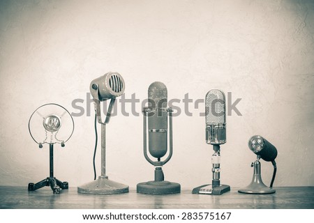 Retro microphones for press conference or interview. Vintage old style sepia photo