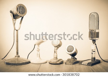 Retro old microphones for press conference or interview. Vintage style sepia photo