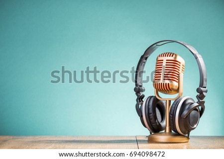 Retro golden microphone and headphones on table front gradient aquamarine background. Vintage old style filtered photo Stockfoto © 