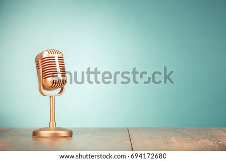 Retro golden microphone for press conference or interview on table front gradient mint green background. Vintage old style filtered photo Stockfoto © 