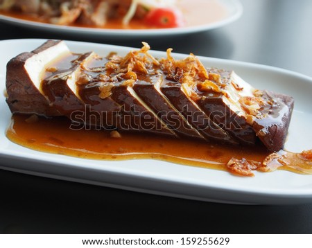 Chinese food Tofu (Soy-bean Curd) with soy sauce on white dish
