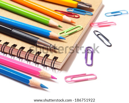 notebook and color pencils stationery isolated on white background