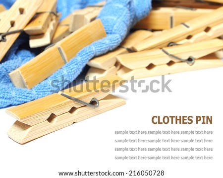 Wooden clothes pin and laundered denim fabric isolated on white background