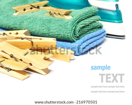 Wooden clothes pin and iron laundered fabric isolated on white background