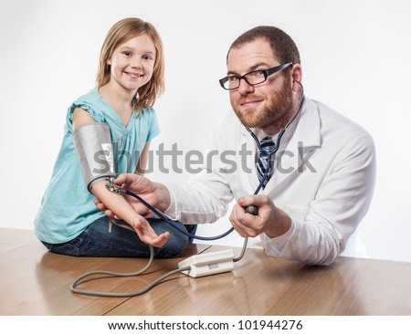 Smiling doctor and girl looking hopeful about routine check up blood pressure test and stethoscope
